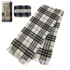 Burberry Vintage Cashmere Scarf in beige with classic plaid pattern, pre-owned and in excellent condition. 64 x 13 inches, fringed edges, made in Scotland.