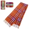 Pre-owned Burberry Nova Check Cashmere Scarf in vibrant orange with classic plaid pattern. 100% cashmere, made in Scotland, featuring fringed edges and Burberry logo.