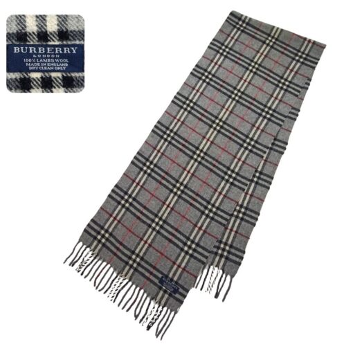 An authentic pre-owned Burberry 100% lambswool scarf in a classic gray check pattern, featuring fringe accents and a soft, luxurious feel.